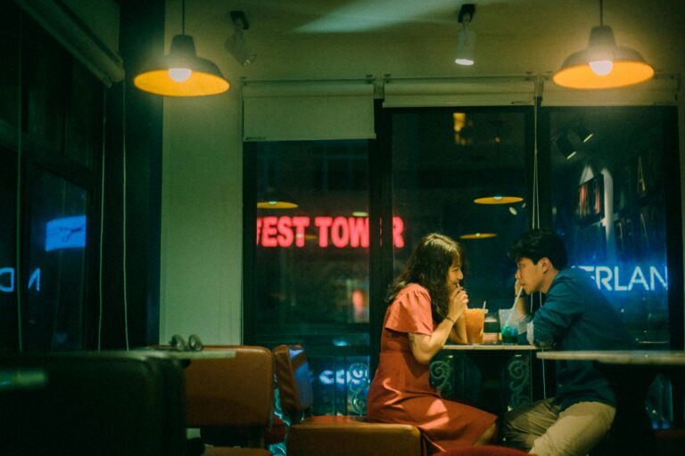 Couple enjoys drinks and a quiet evening inside a cozy café.